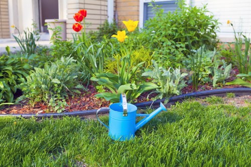 Satisfied homeowner reviewing cleared and organized garden in Spitalfields